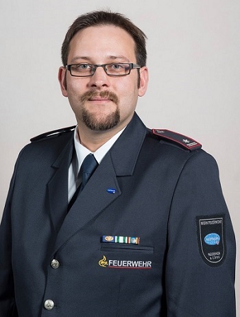 Portrait shot of Steffen Hellmann in his uniform.