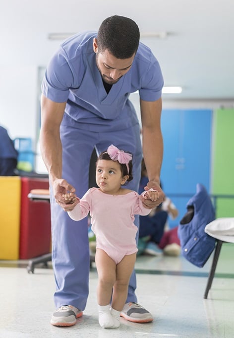 nurse with a little kid in pink dress