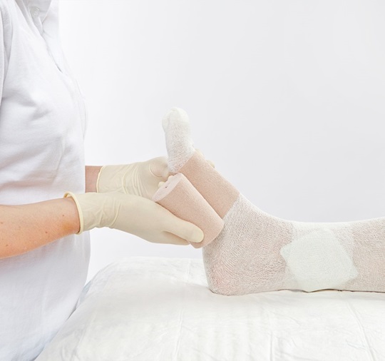 A nurse is treating a wound