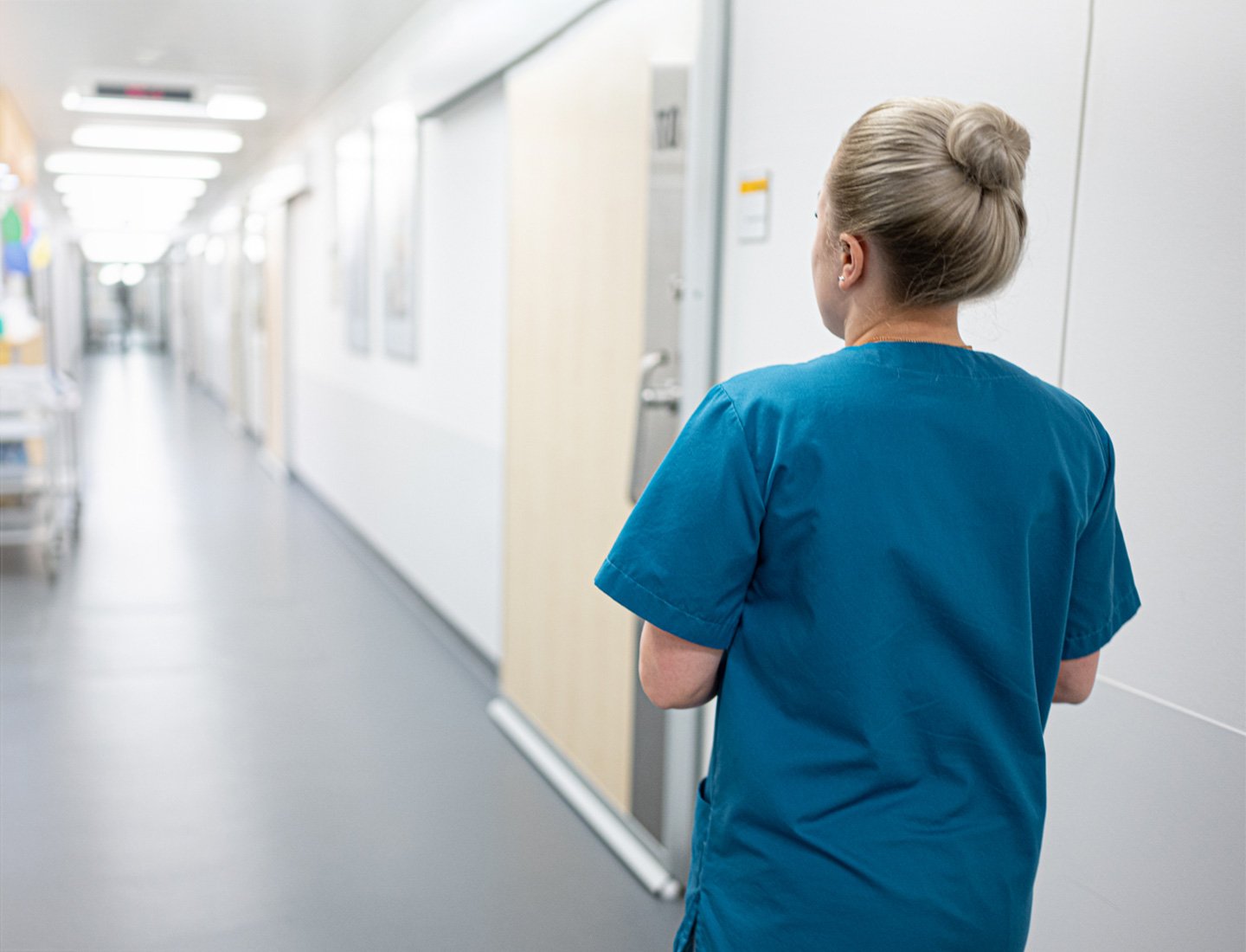 Nurse walking down hospital corridor